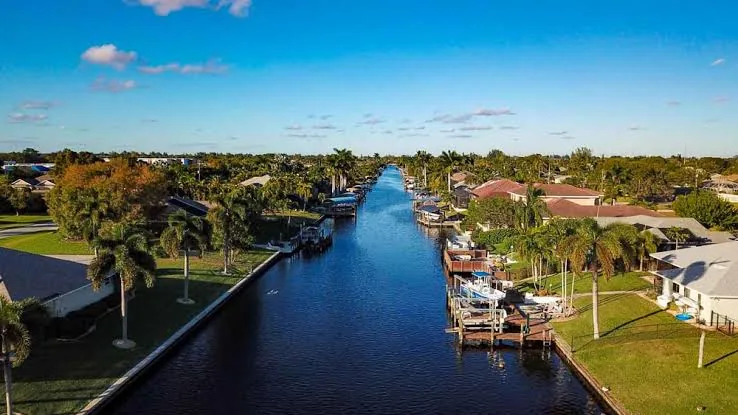 Aerial view of a Cape Coral canal lined with waterfront homes and boat docks