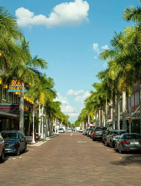 Palm-lined brick street in the Fort Myers River District near the Arcade Theatre