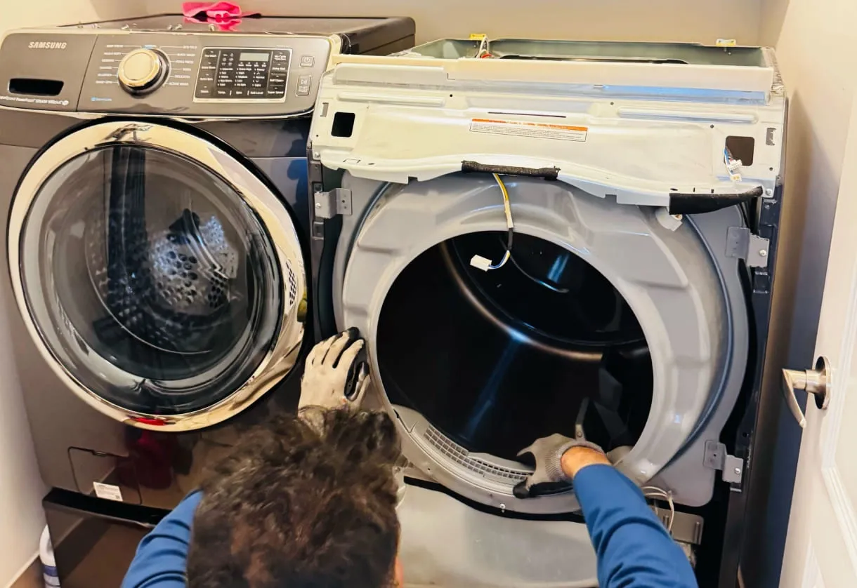 Technician removing the front panel of a front-load dryer